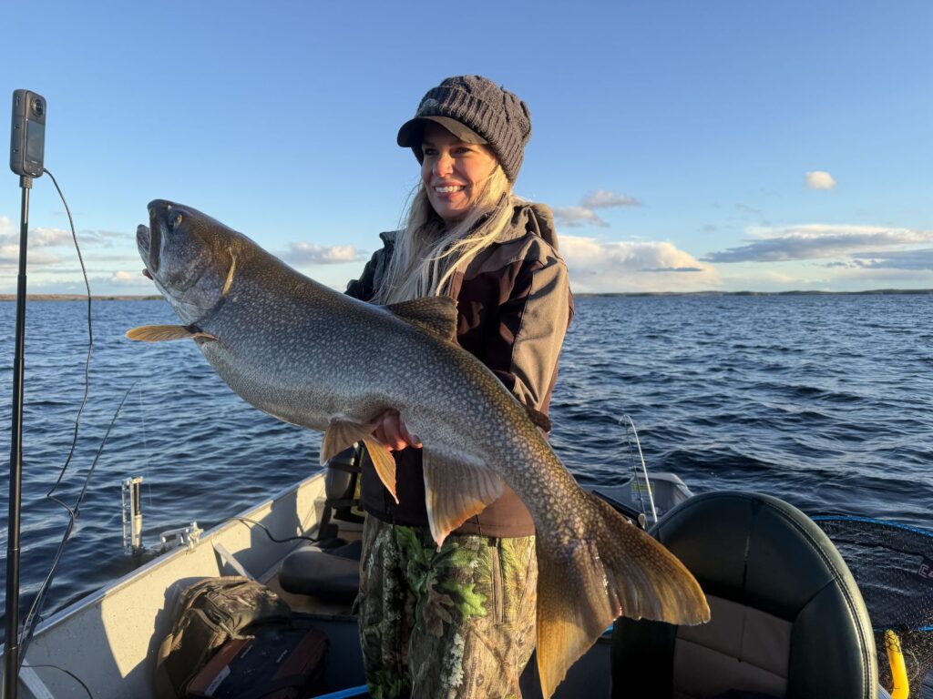 Nicole Stone holding a trophy lake trout on Kamuchawie Lake, a Bakers Narrows Lodge fly-in outpost