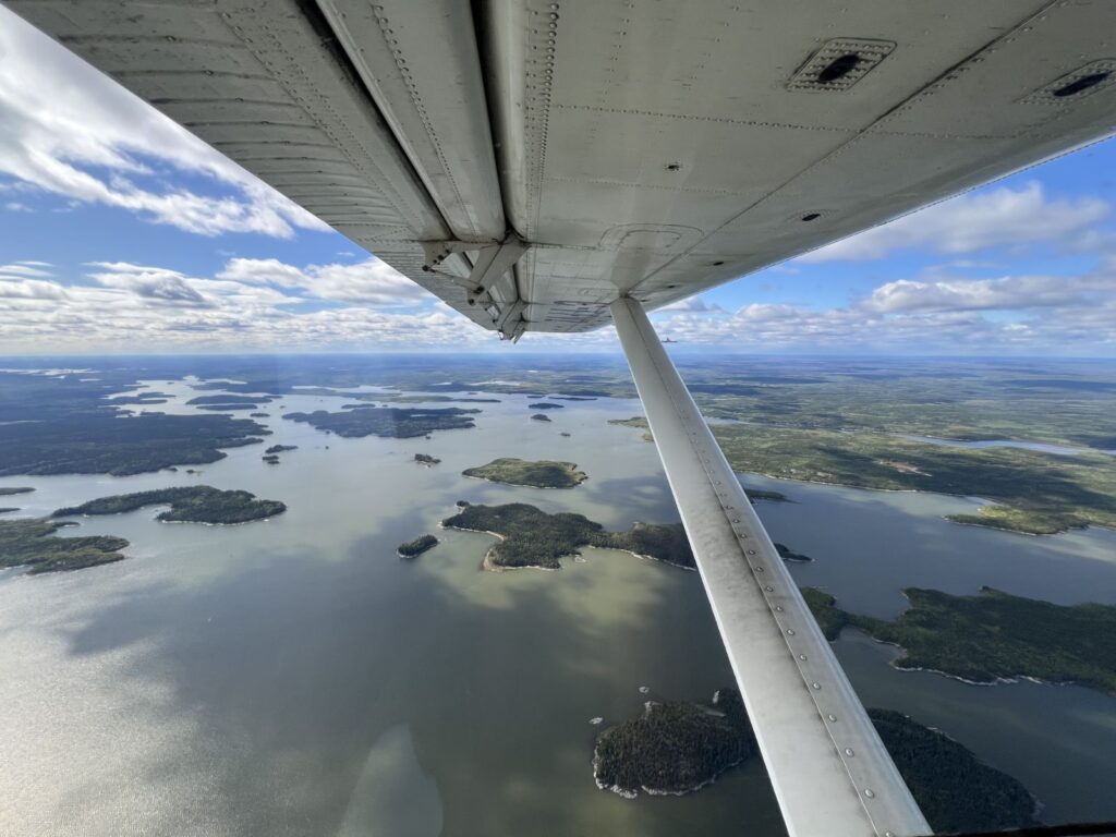View from the floatplane wing over northern Manitoba lakes on the way to Kamuchawie Lake