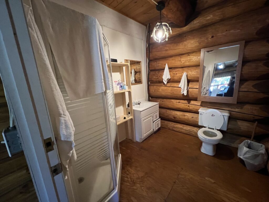 Full bathroom with shower inside the log cabin at the Kamuchawie Lake fly-in outpost