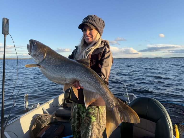 Nicole Stone holding a trophy lake trout on Kamuchawie Lake, a Bakers Narrows Lodge fly-in outpost