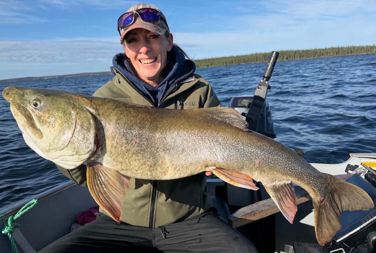 Christina, the outpost cook, holding a trophy lake trout over 40 inches on Kamuchawie Lake